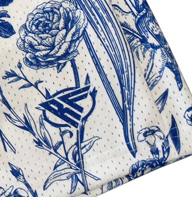 Floral patterned shorts with blue flowers on a white background