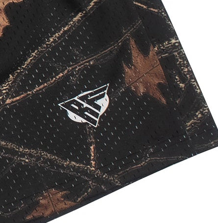 Close-up of a tree camo patterned fabric with a logo on a white background