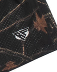 Close-up of a tree camo patterned fabric with a logo on a white background