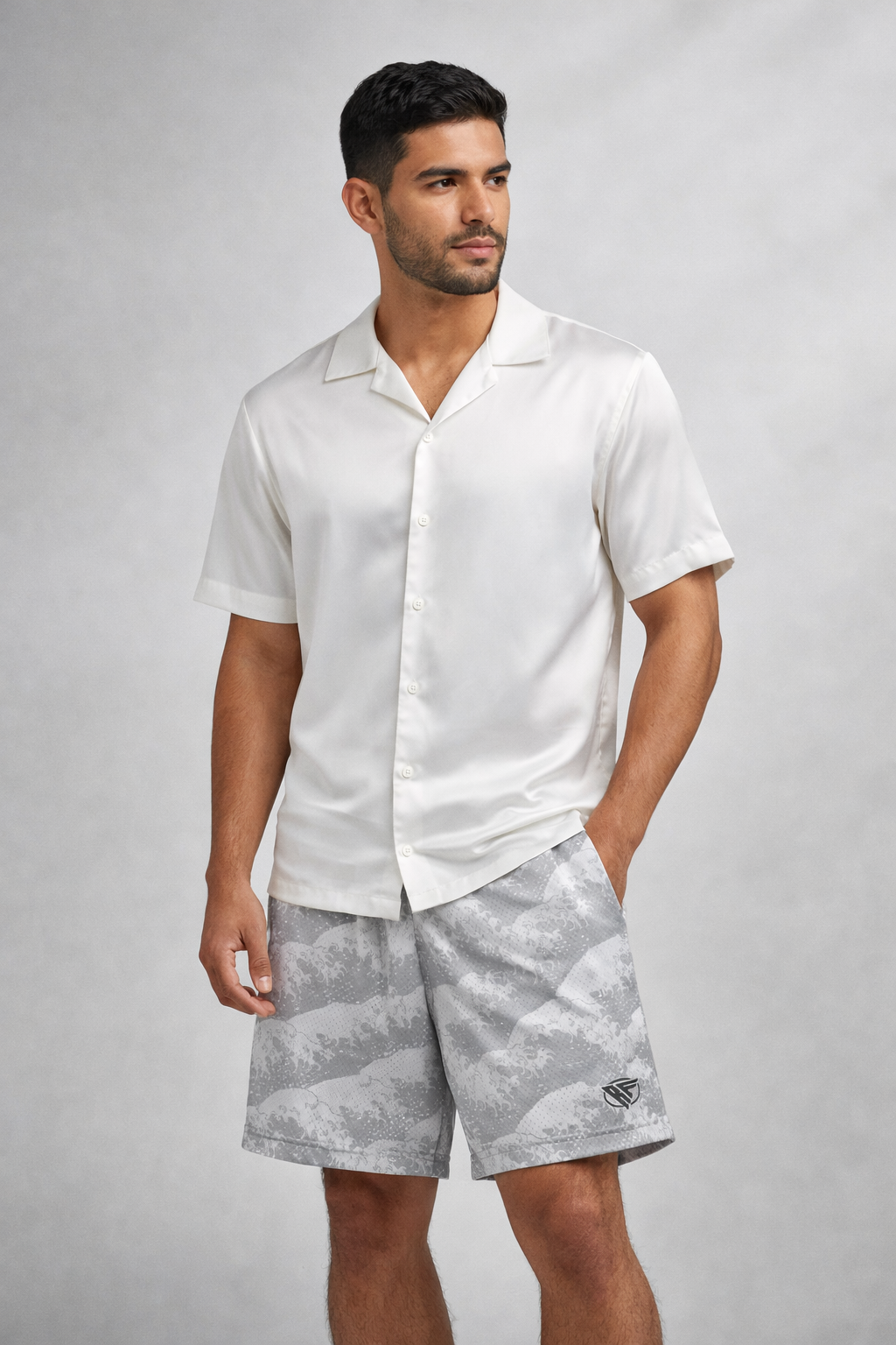 Man wearing a white short sleeve button up silk shirt and RF-Wear Ocean Waves Shorts in Grey/White