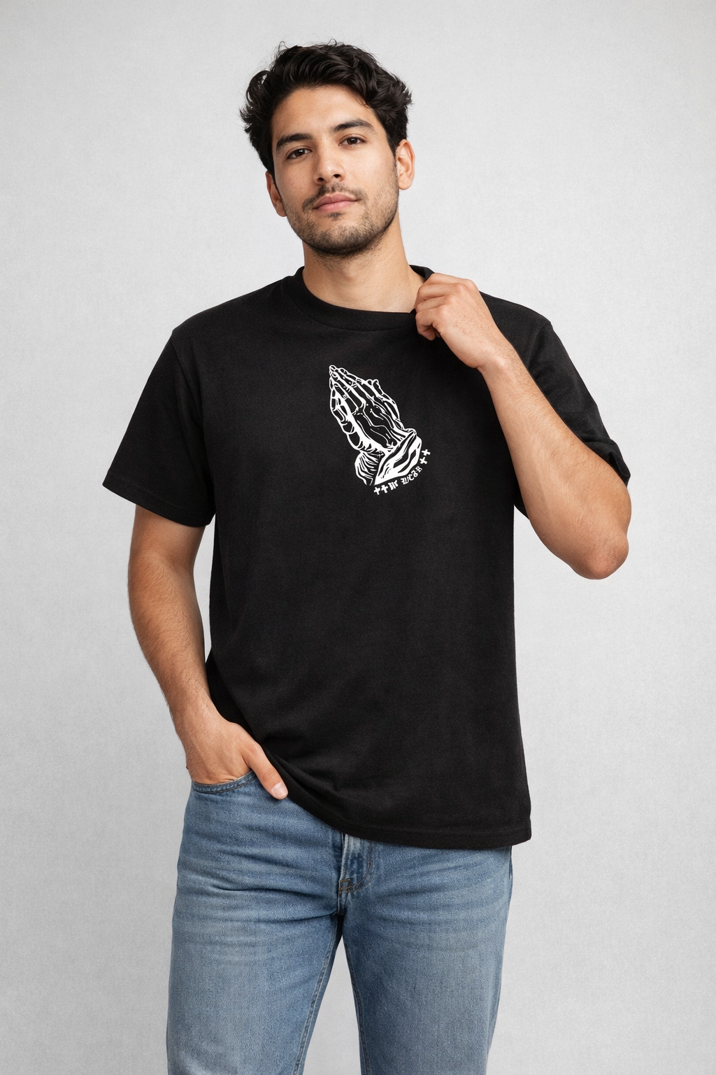Man wearing jeans and a RF-Wear Praying Hands T-Shirt in Black