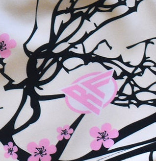 Close-up of RF-Wear Swim Trunks - Cherry Blossom (Lined) in Cream with RF logo