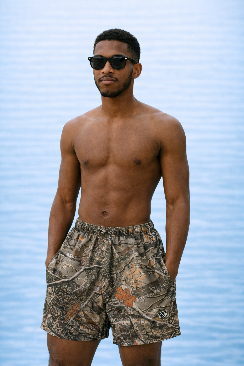 Man wearing RF-Wear Swim Trunks Tree Camo (Lined) in Tan