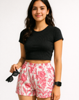Woman wearing a black top and RF-Wear Women's  Porcelain Shorts in White/Fuchsia