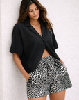 Woman wearing a black blouse with RF-Wear Women's Animal Print - Mash-up - in Black/White
