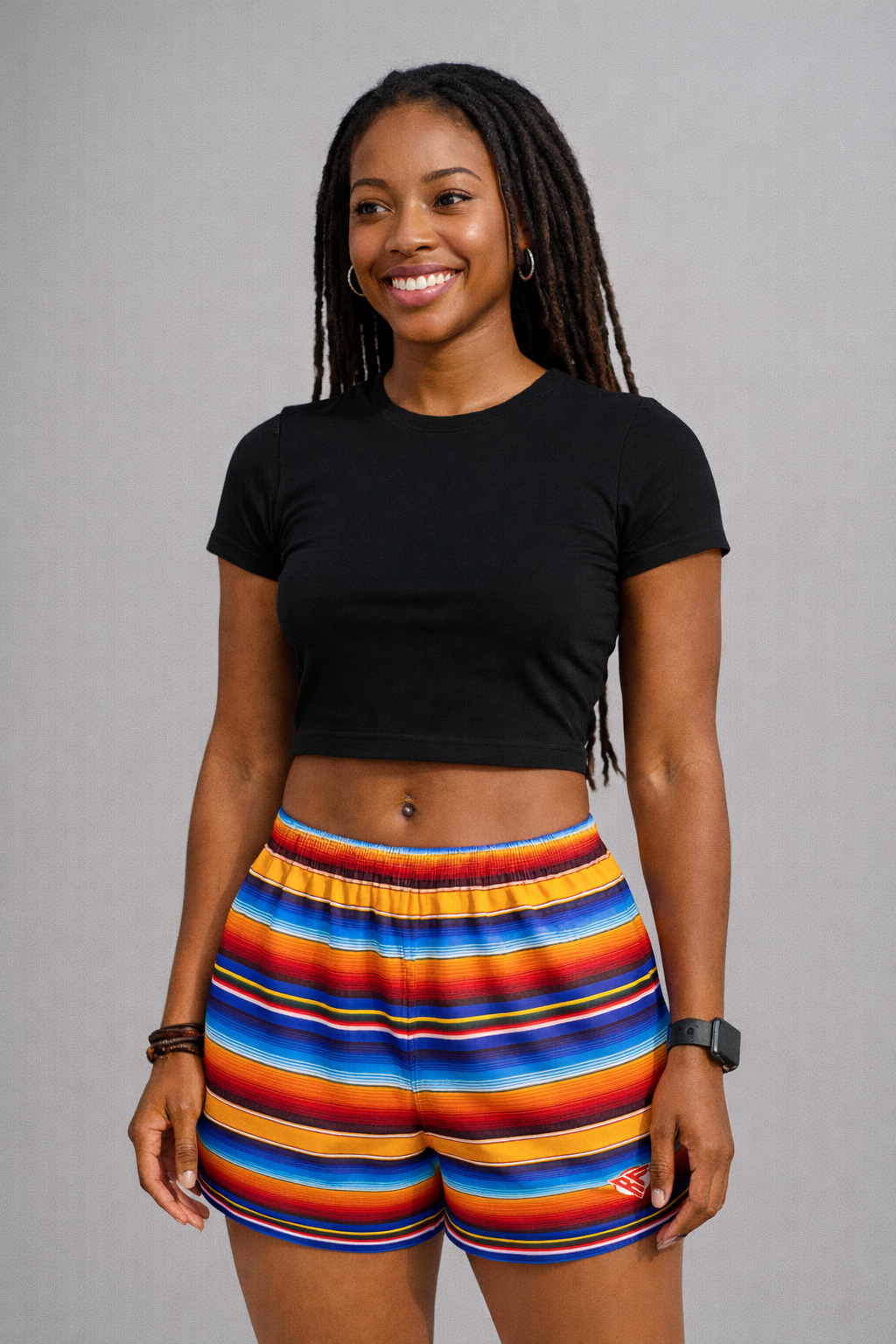 Woman wearing a black top and RF-Wear Women's Baja Shorts in Multicolors