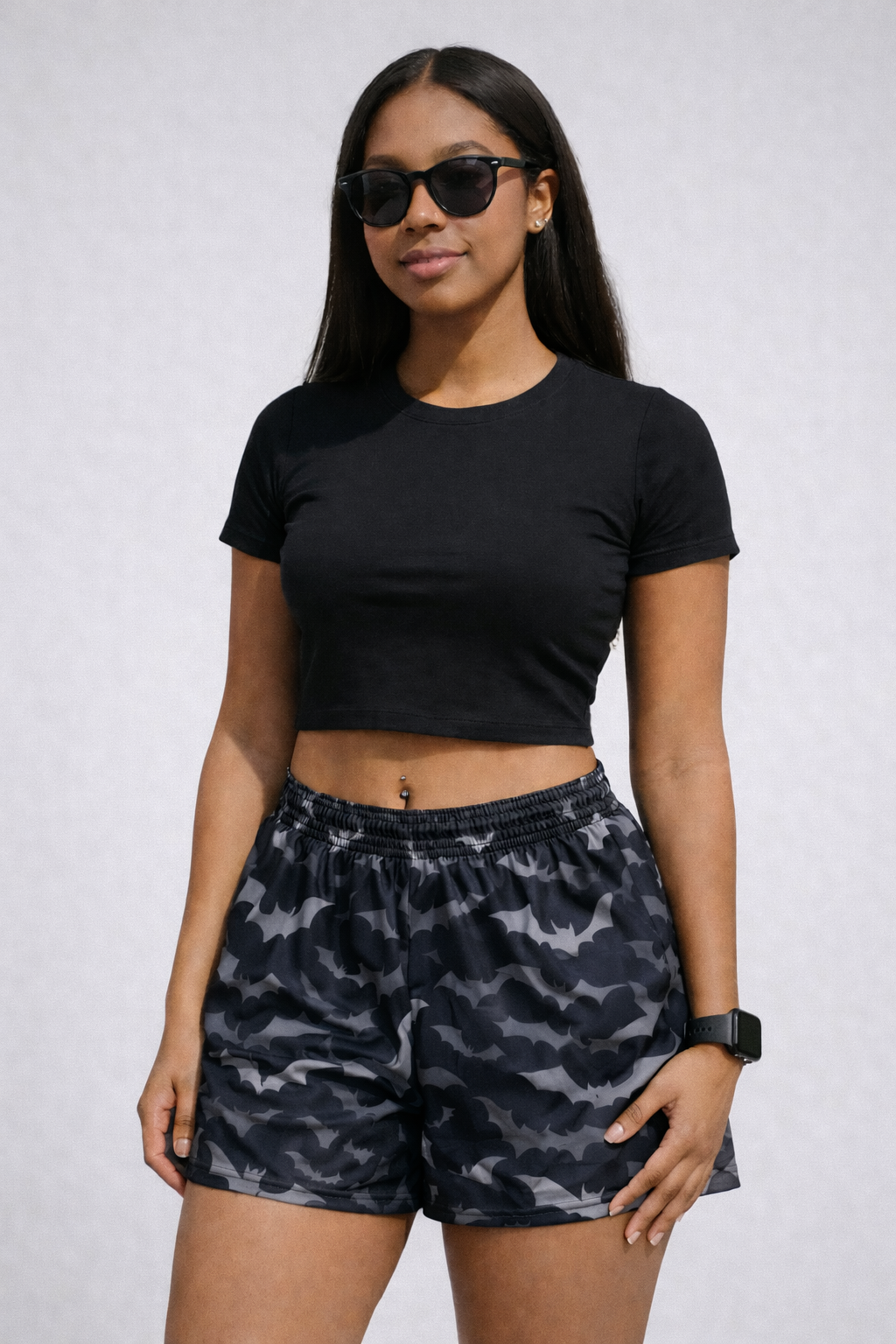 Woman wearing a black crop top and RF-Wear Women's Bats Shorts in Black/Grey