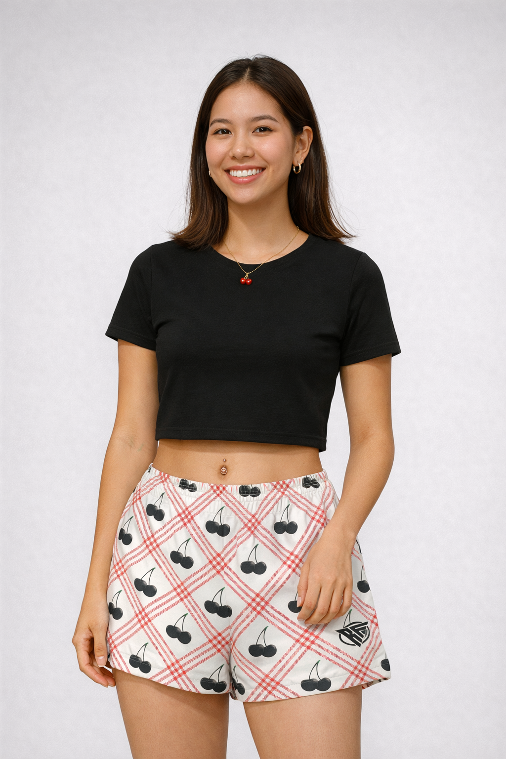Woman wearing a black crop top and RF-Wear Women's Black Cherry Shorts in Red/White
