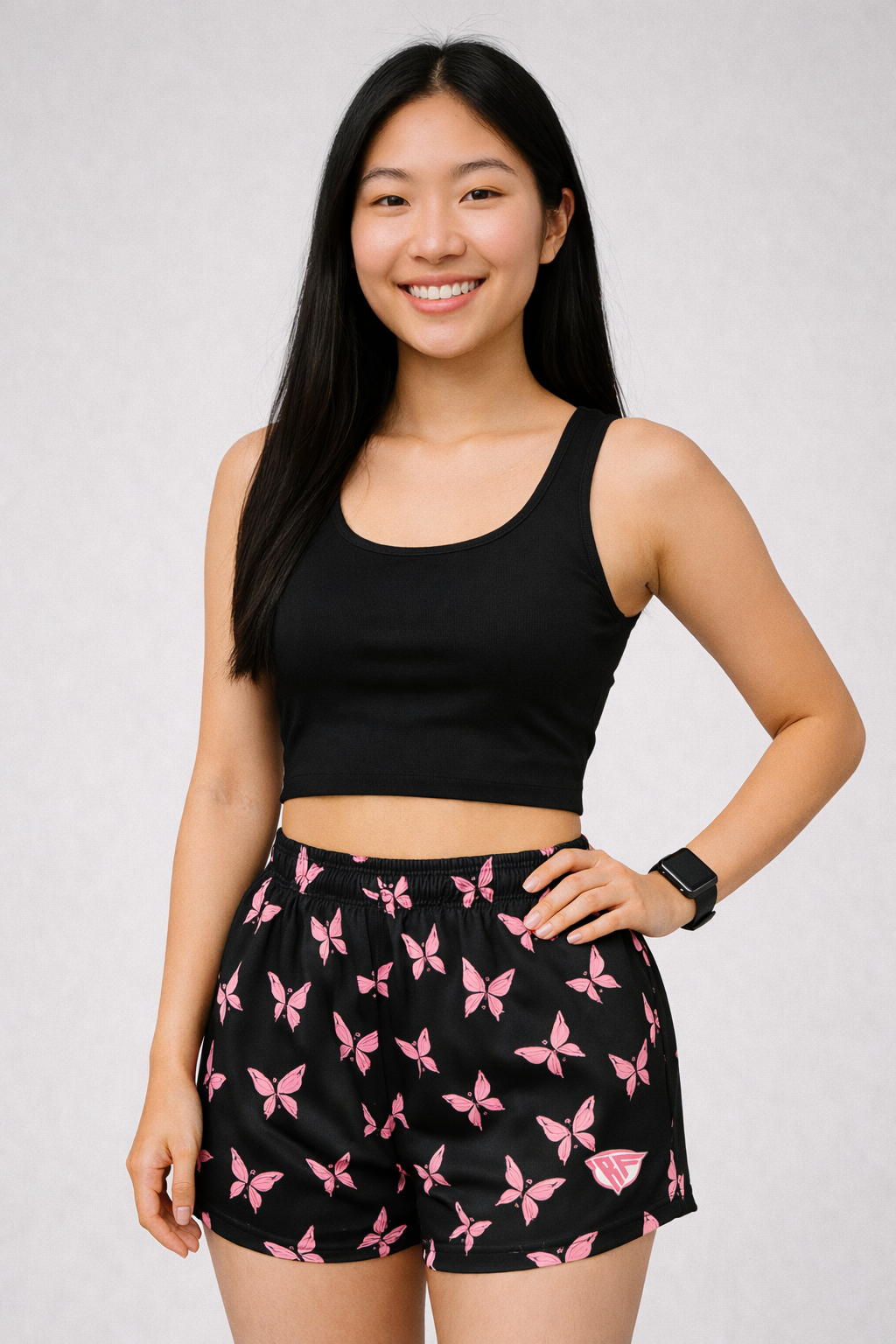 Woman wearing a black top and RF-Wear Women's Butterfly Shorts in Black/Pink