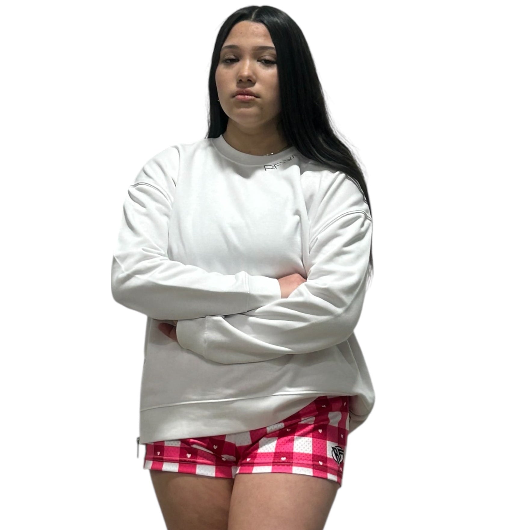 Picture of a women in a RF-Wear white hoodie and RF-Wear checkered/heart shorts in white and pinks.
