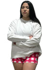Picture of a women in a RF-Wear white hoodie and RF-Wear checkered/heart shorts in white and pinks.