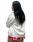 Picture of a women in a RF-Wear white hoodie and RF-Wear checkered/heart shorts in white and pinks.