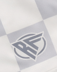 Close-up of RF-Wear Women's Checkered Shorts in Grey with RF logo