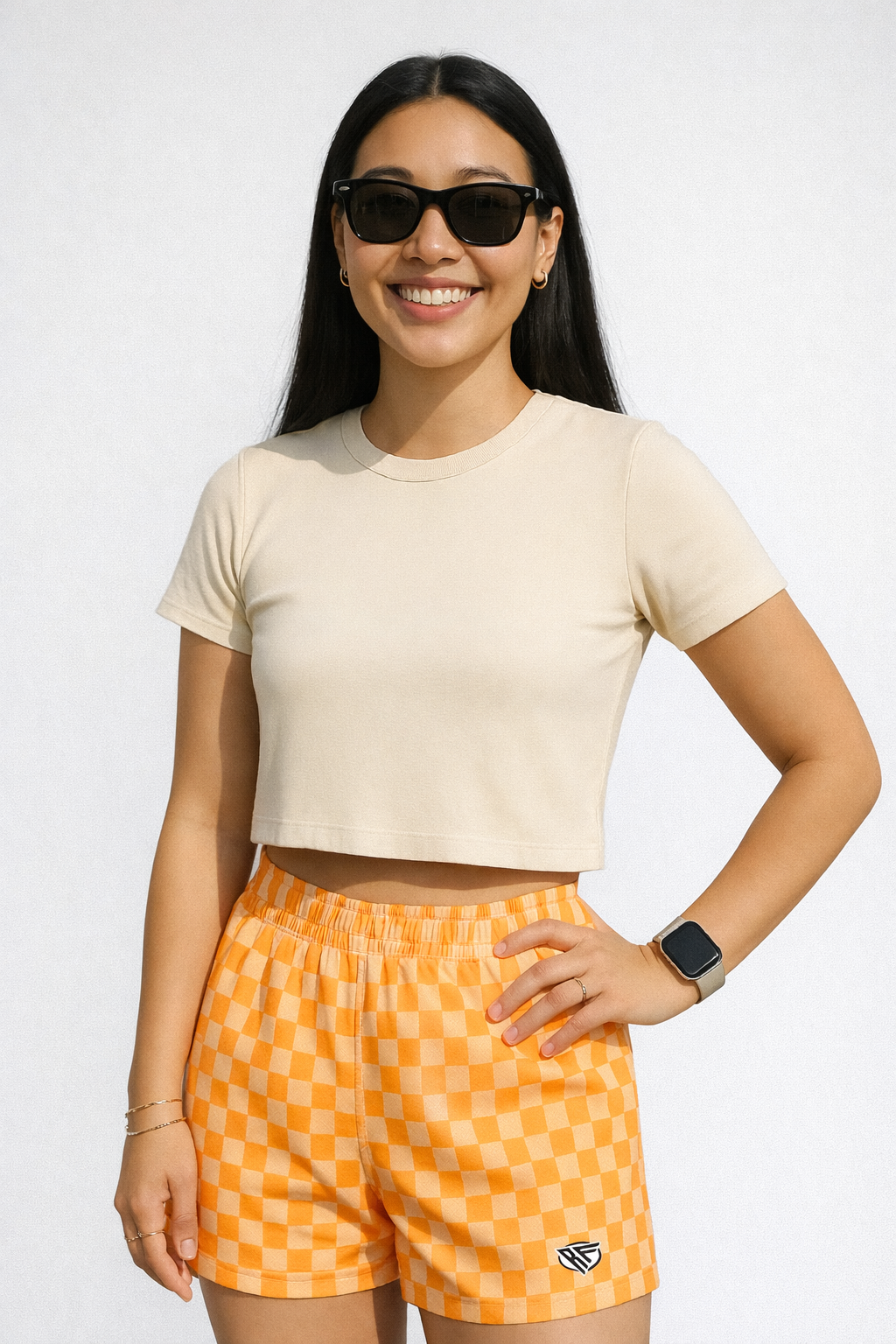 Woman wearing a top and RF-Wear Women's Checkered Shorts in Peach