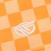 Close-up of RF-Wear Women's Checkered Shorts in Peach with RF logo