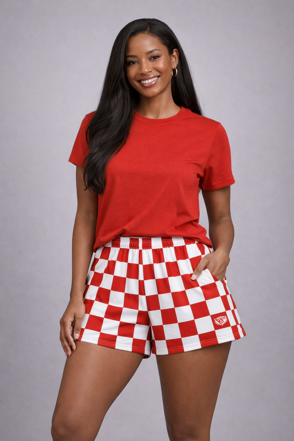 Woman wear a red top and red and white checkered shorts
