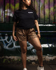 Woman wearing a black t-shirt and RF-Wear Women's Animal Print Shorts - Cheetah in Brown