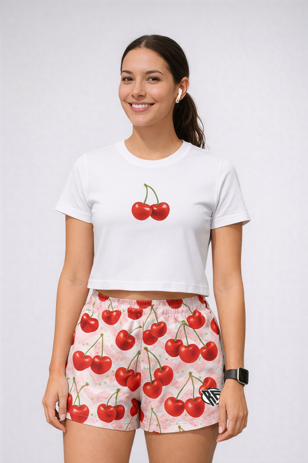 Woman wearing a white top and RF-Wear Women's Cherry Chevron Shorts in Pink/Red
