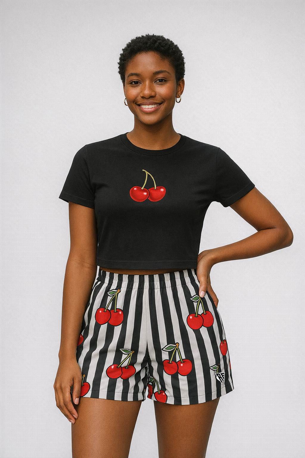 Woman wearing a black top and RF-Wear Women's Cherry Stripe Shorts in Black/White/Red