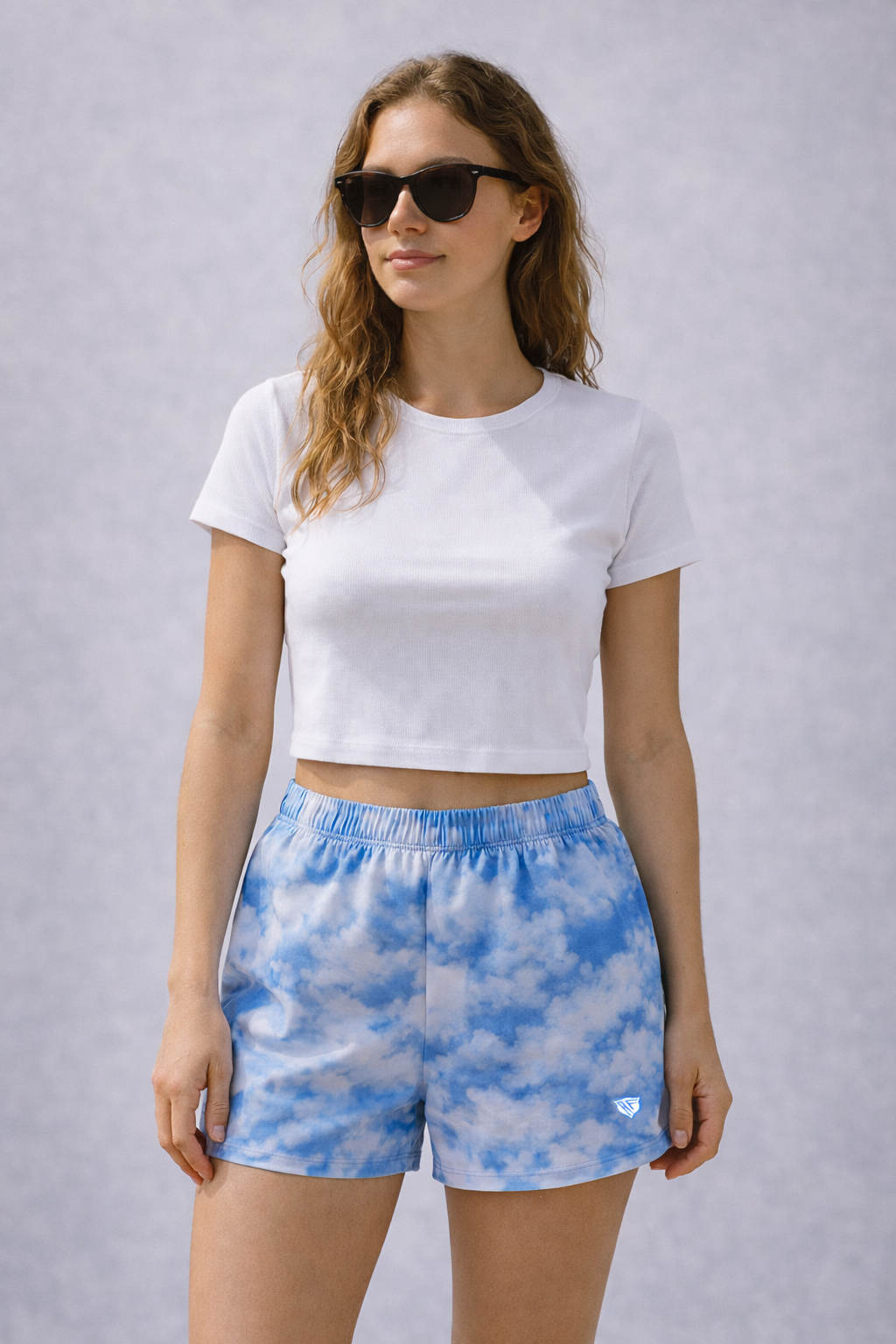 Woman wearing a white top and RF-Wear Women's Cloud Shorts in Blue 