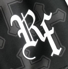 Close-up of RF-Wear Women's Cross 2.0 Shorts in Black/Charcoal with RF logo