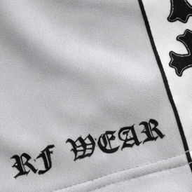 Close-up of RF-Wear Women's Cross Trim Shorts in Grey with RF-WEAR logo on hemline