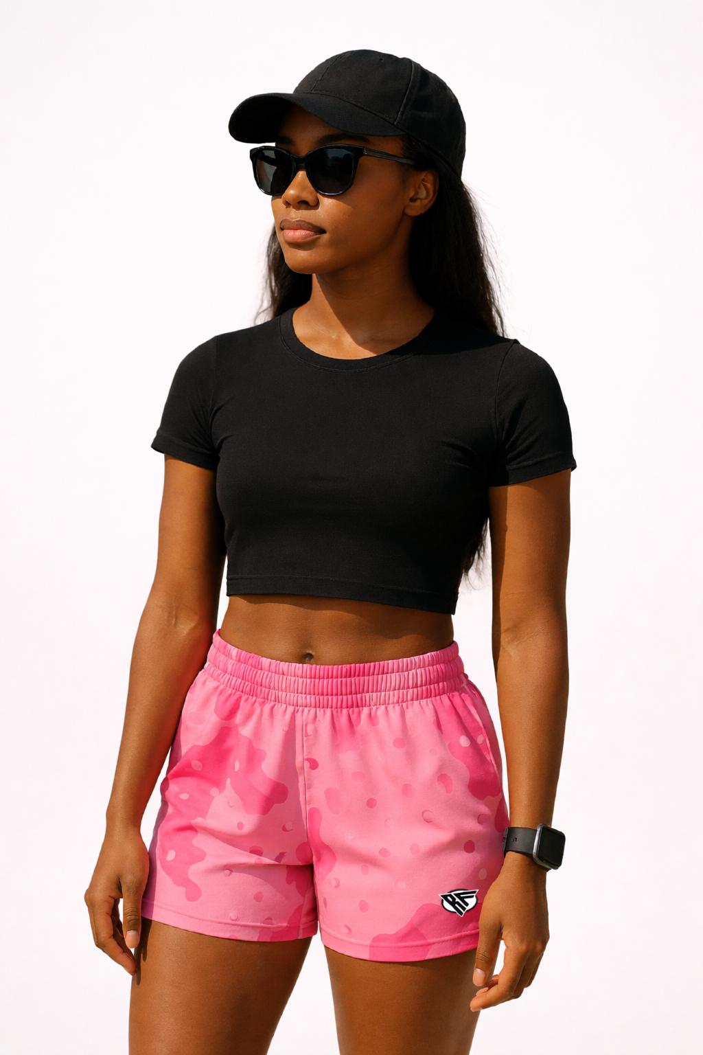 Woman wearing with black top and RF-Wear Women's Desert Camo Shorts in Pink