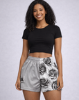 Woman wearing a black short sleeve crop top and RF-Wear Floral Rose Shorts in Grey/White