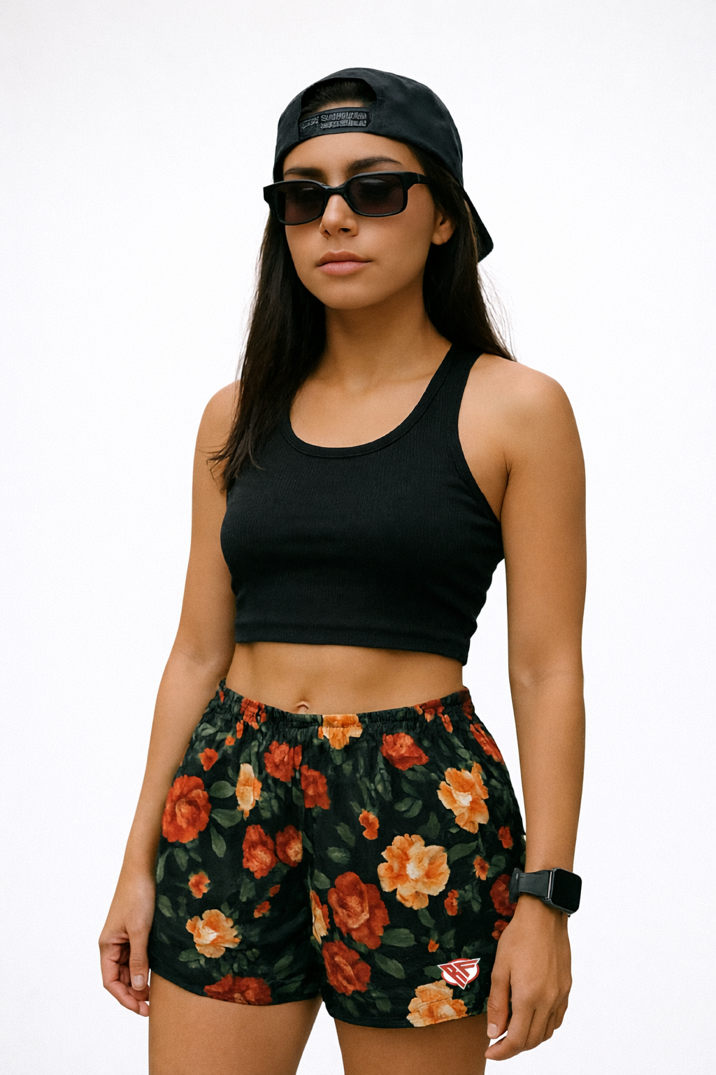 Woman Wearing a black top, cap, andRF-Wear Women's Floral Shorts in Black/Red/Peach