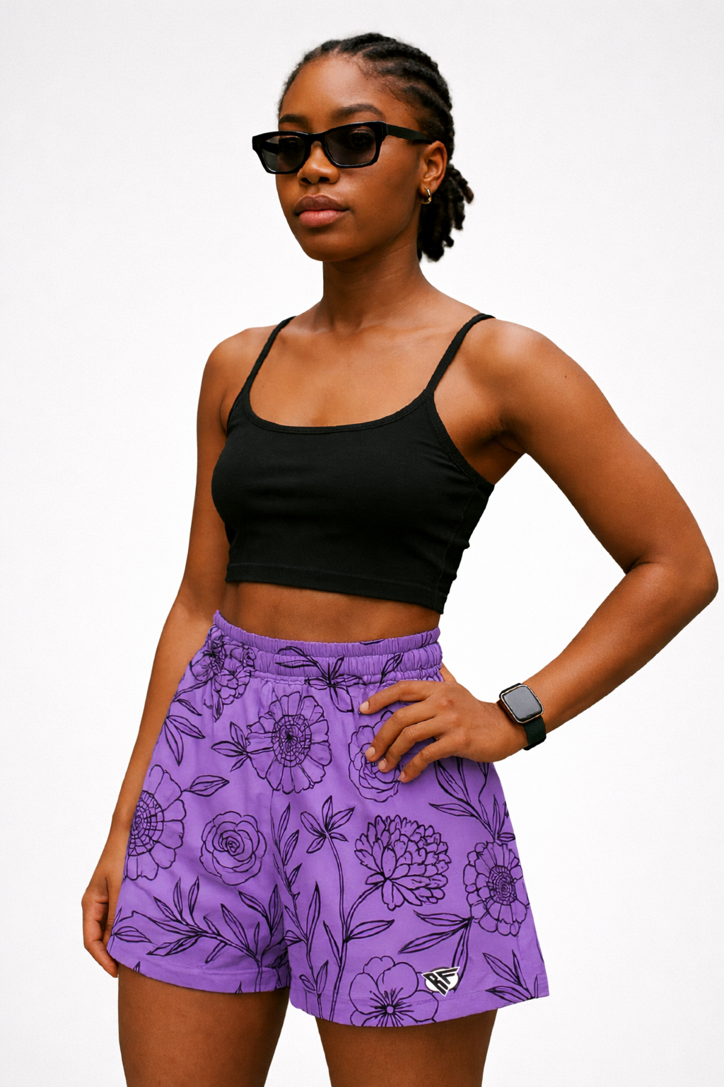 Woman wearing a black top and RF-Wear Women's Floral Shorts in Lavender/Black 