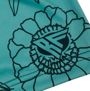 Close-up of RF-Wear Women's Floral Shorts in Teal/Black with RF logo