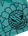 Close-up of RF-Wear Women's Floral Shorts in Teal/Black with RF logo
