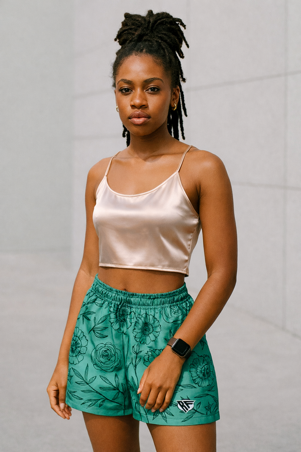 Woman wearing a silk to and RF-Wear Women's Floral Shorts in Teal/Black