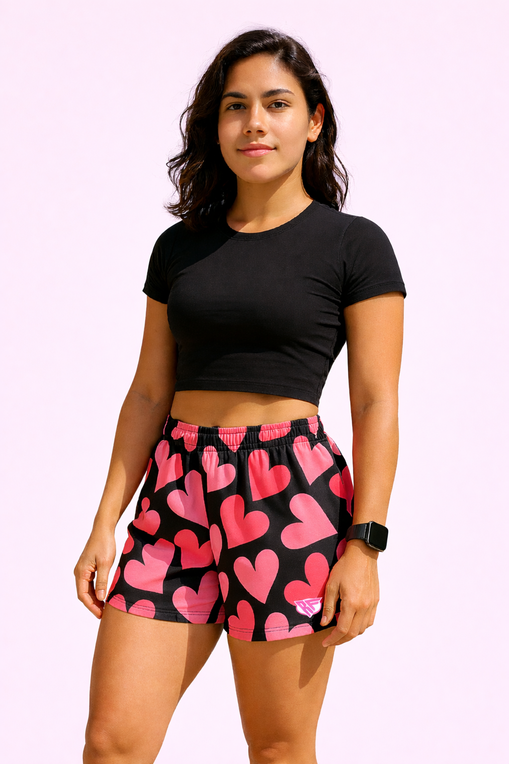 Woman wearing a black top and RF-Wear Women's Heart Shorts in Black/Pink