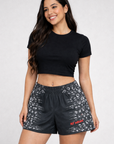 Woman wearing a black crop top and RF-Wear Women's Horror 2.0 Shorts in Black