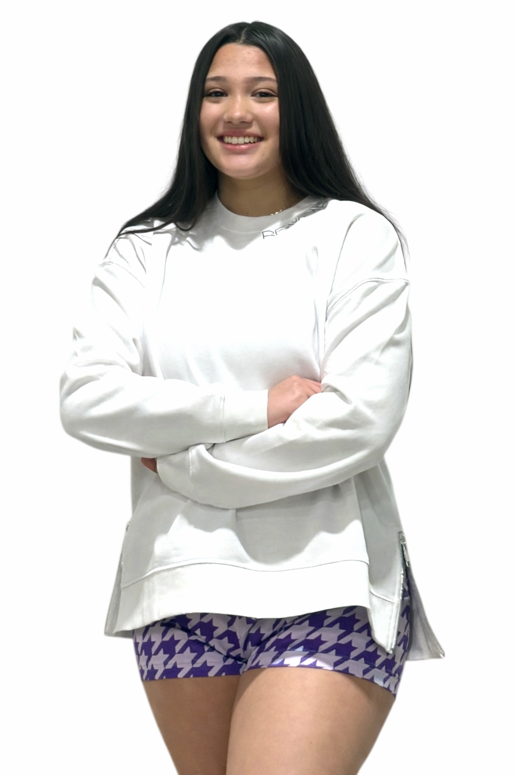 Woman wearing a white sweatshirt and women's houndstooth shots in lavender