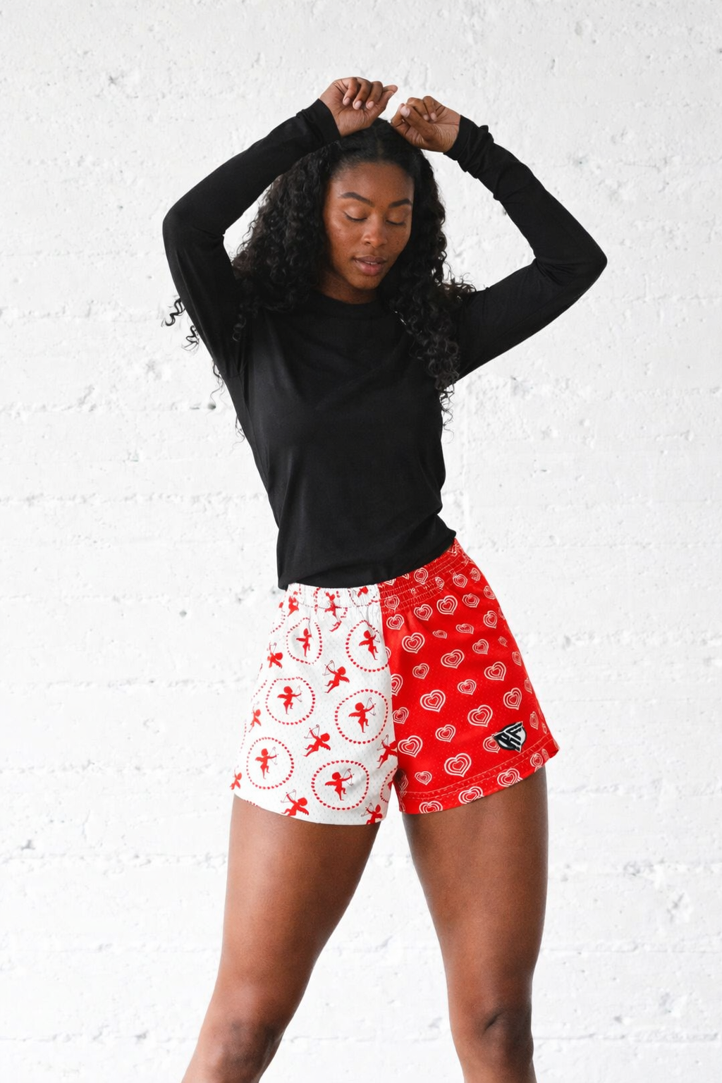 Woman wearing RF-Wear Women's Mesh Split Cupid/Heart shorts and a black top