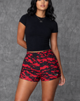 Woman wearing a black cropped top and RF-Wear Women's Mesh Tiger Camo Shorts in Red
