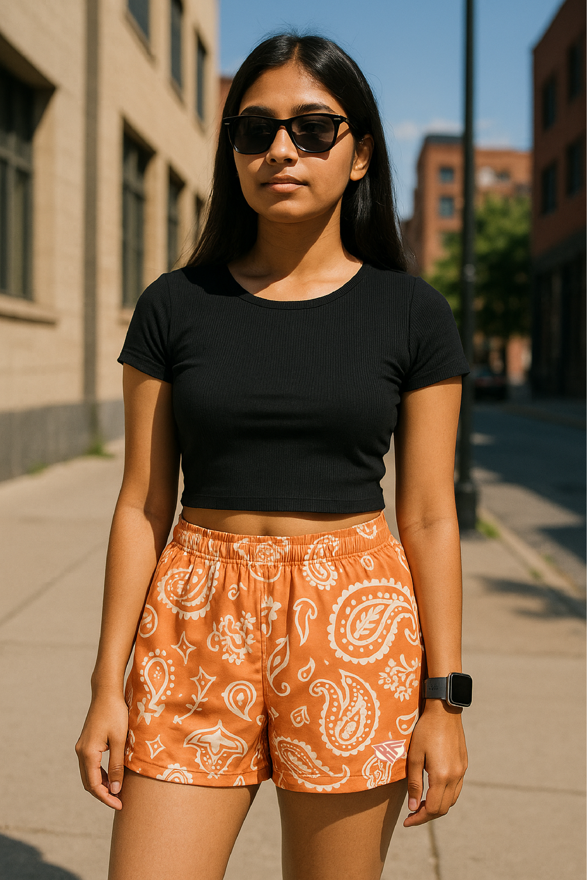Woman standing in city wearing RF-Wear Women's Paisley Shorts - Apricot/Cream - Front View