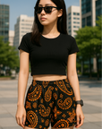 Woman in the city wearing RF-Wear Women's Paisley Shorts - Black/Orange - Front View