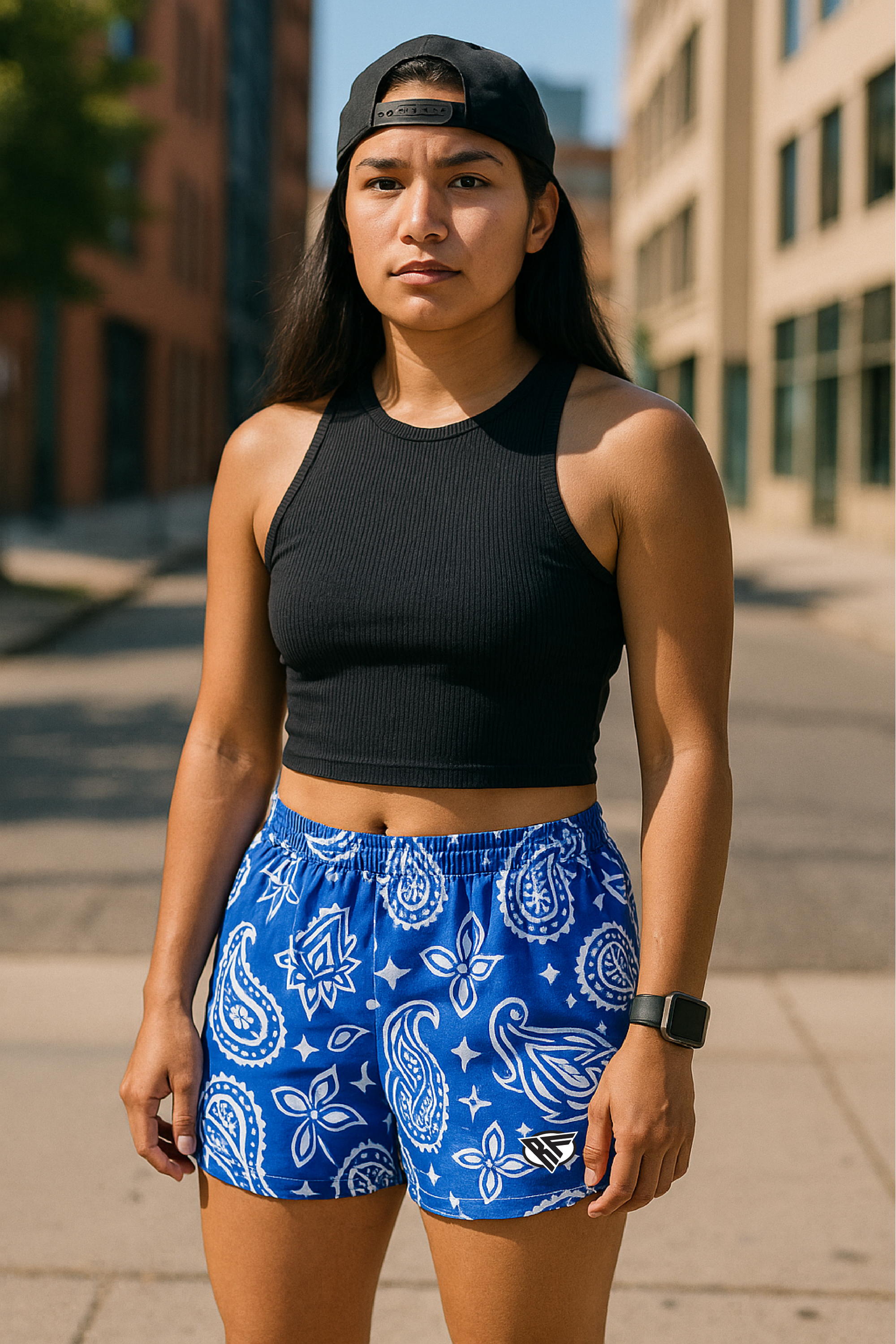 Woman on the city sidewalk wearing RF-Wear Women's Paisley Shorts - Blue/White - Front View