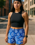 Woman on the city sidewalk wearing RF-Wear Women's Paisley Shorts - Blue/White - Front View
