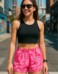 Women standing near city streets wearing RF-Wear Women's Paisley Shorts - Fuchsia/White - Front View