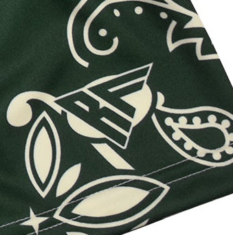 Close-up of green/cream paisley pattern and  a brand logo.