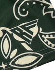 Close-up of green/cream paisley pattern and  a brand logo.