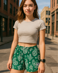 Woman standing in city wearing RF-Wear Women's Paisley Shorts - Green/White - Front View