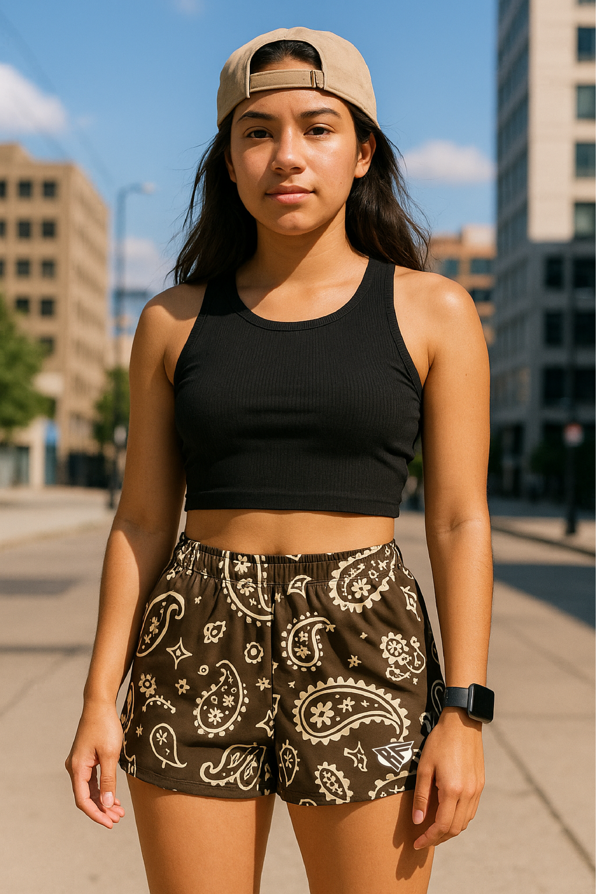 Woman standing on city sidewalk wearing RF-Wear Women's Paisley Shorts - Mocha/Cream - Front View