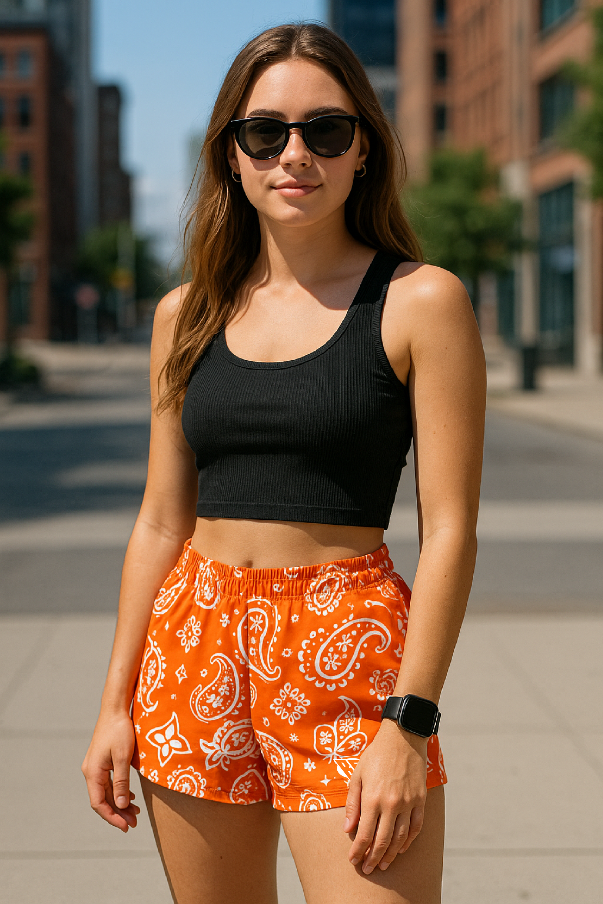 Woman on city street wearing RF-Wear Women's Paisley Shorts - Orange /White - Front View