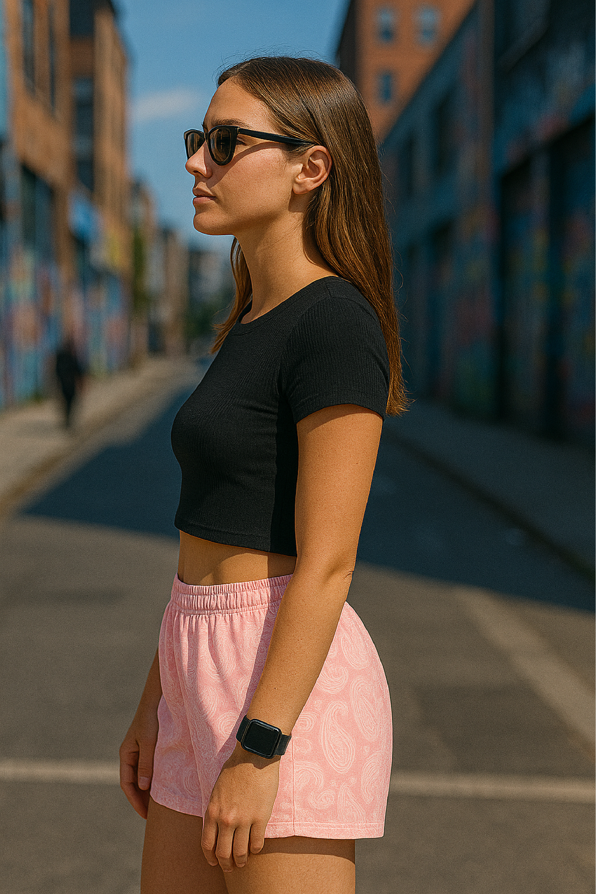 Woman standing on street wearing RF-Wear Women's Paisley Shorts - Pink/Cream - Side View