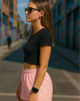 Woman standing on street wearing RF-Wear Women's Paisley Shorts - Pink/Cream - Side View